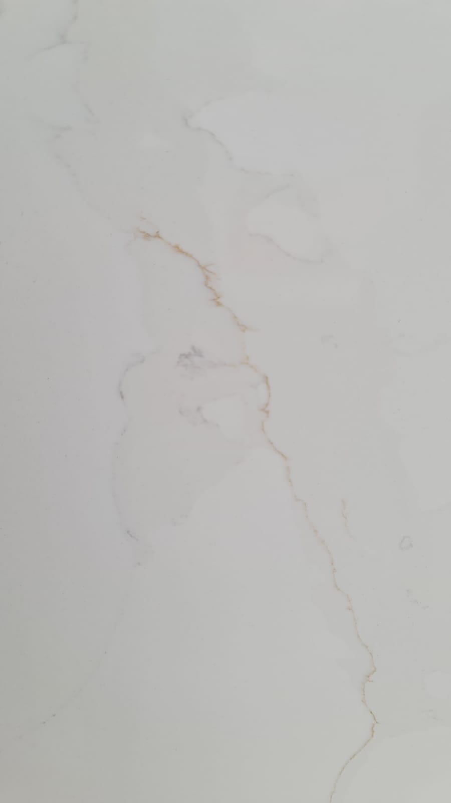 Calacatta Supreme quartz — clean white base with bold grey veining (close-up)